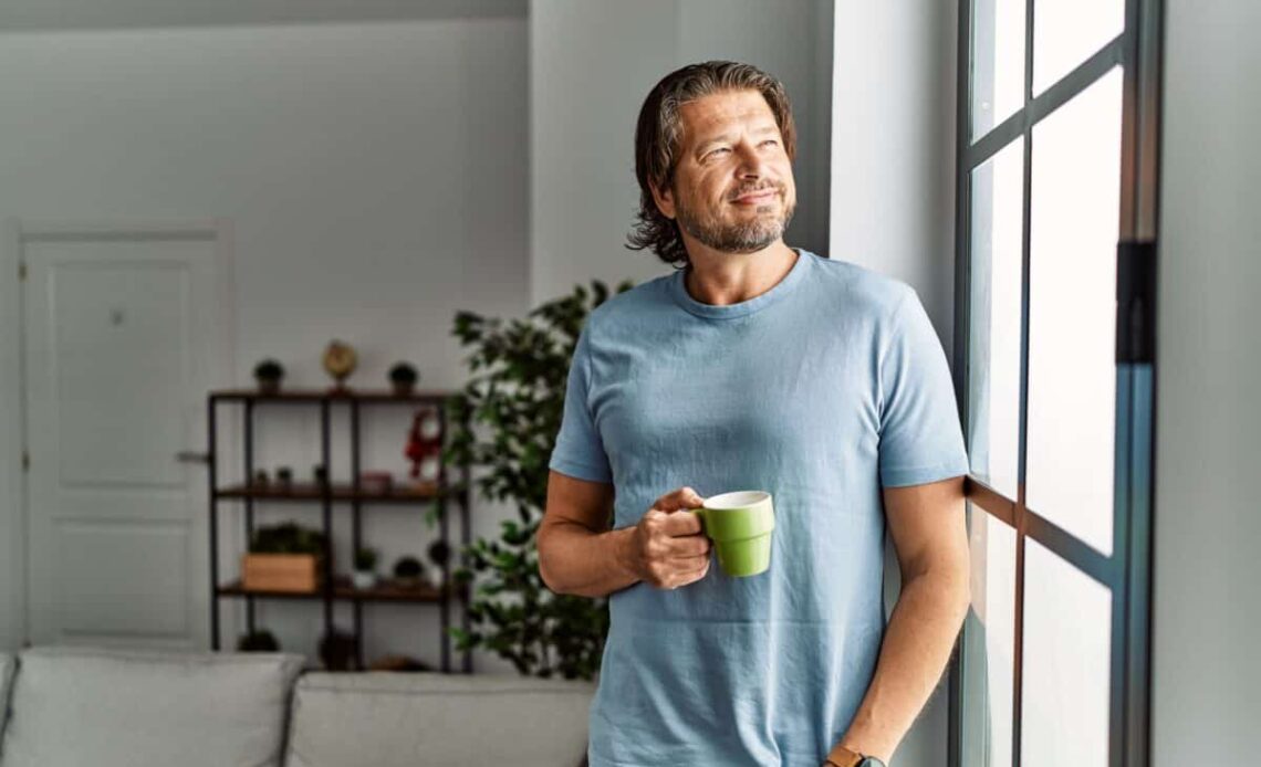 Middle aged man drinks coffee