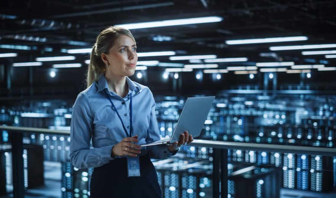 Data center woman holding laptop