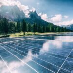 A solar cell panel generates power in a country mountain landscape.