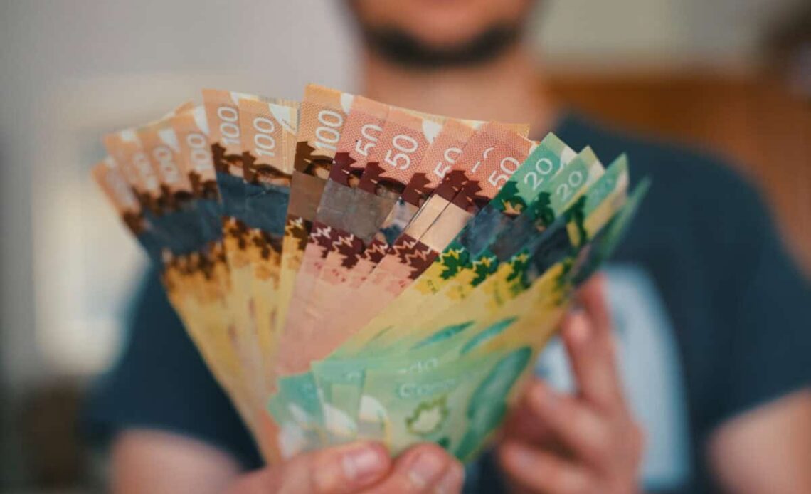 Person holds banknotes of Canadian dollars
