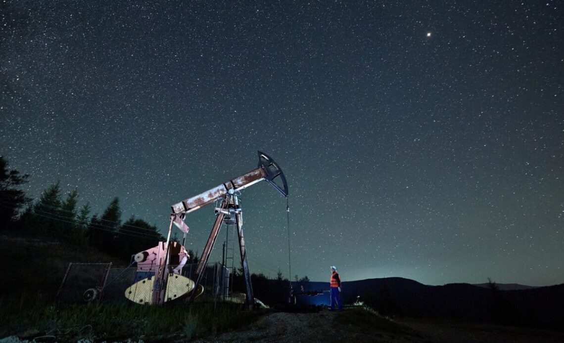 oil pump jack under night sky