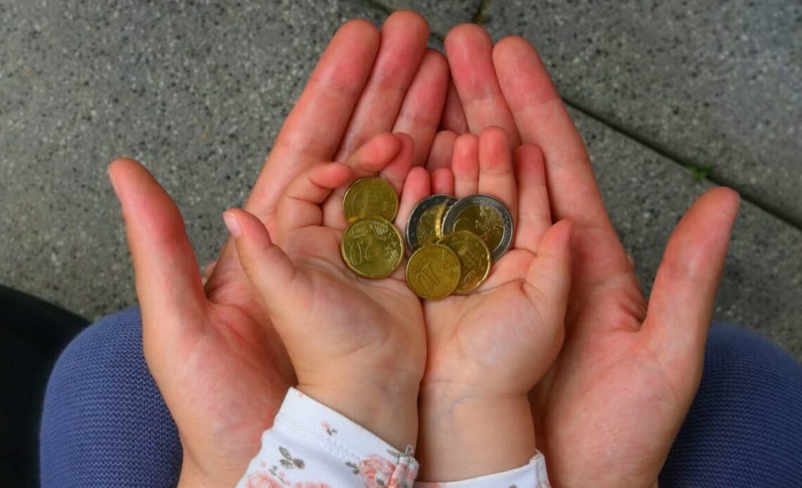 holding coins in hand for the future
