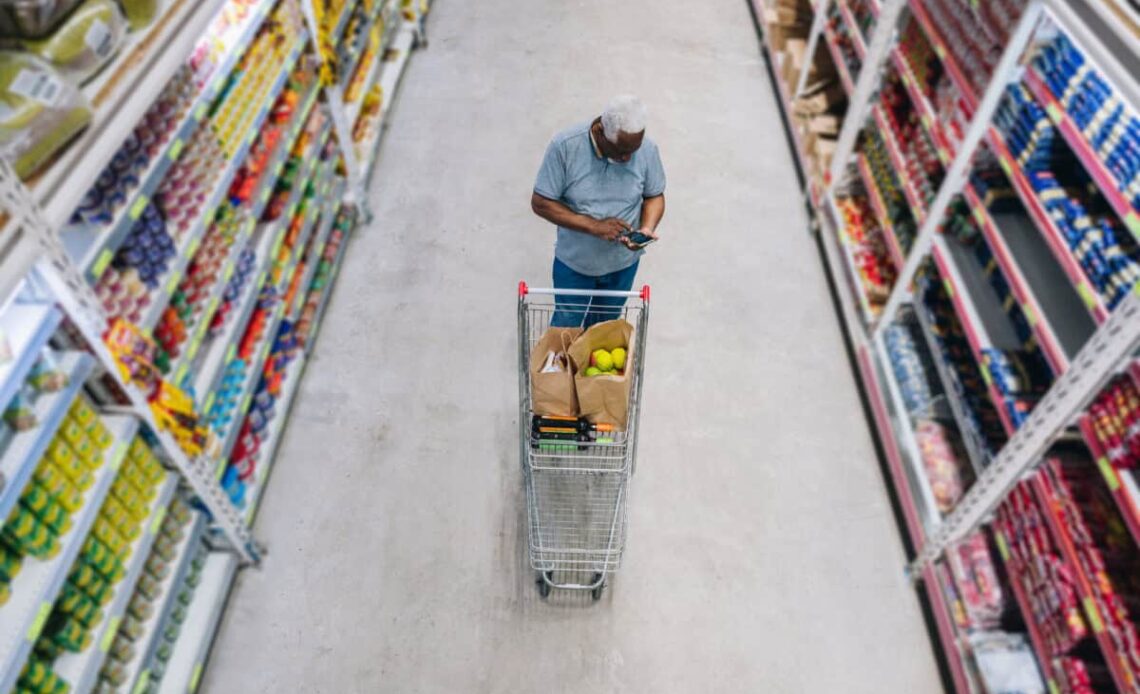 man shops at grocery store