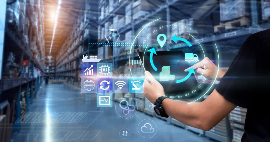 Person uses a tablet in a blurred warehouse as background