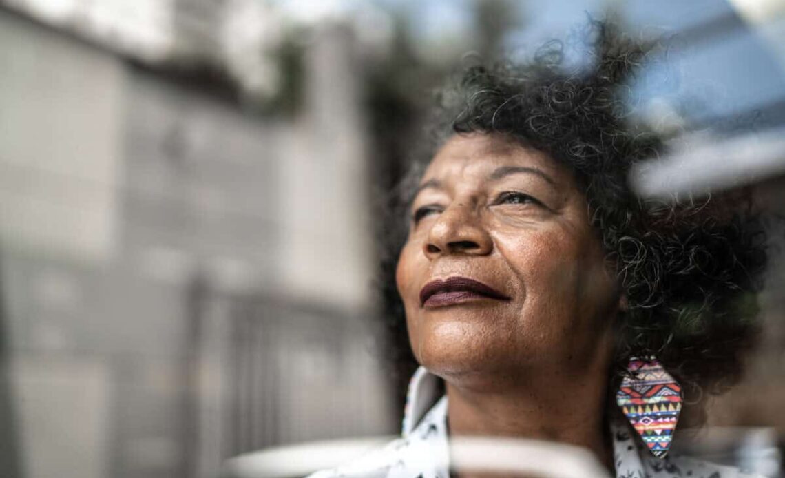 woman gazes forward out window to future