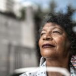 woman gazes forward out window to future